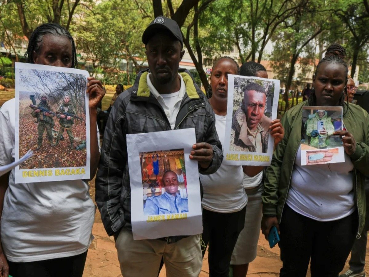 Family members of Kenyans who enlisted in the Russian army to fight in Ukraine hold up photographs of their loved ones during a protest in Nairobi, urging the government to urgently repatriate them and return the remains of those who have died.