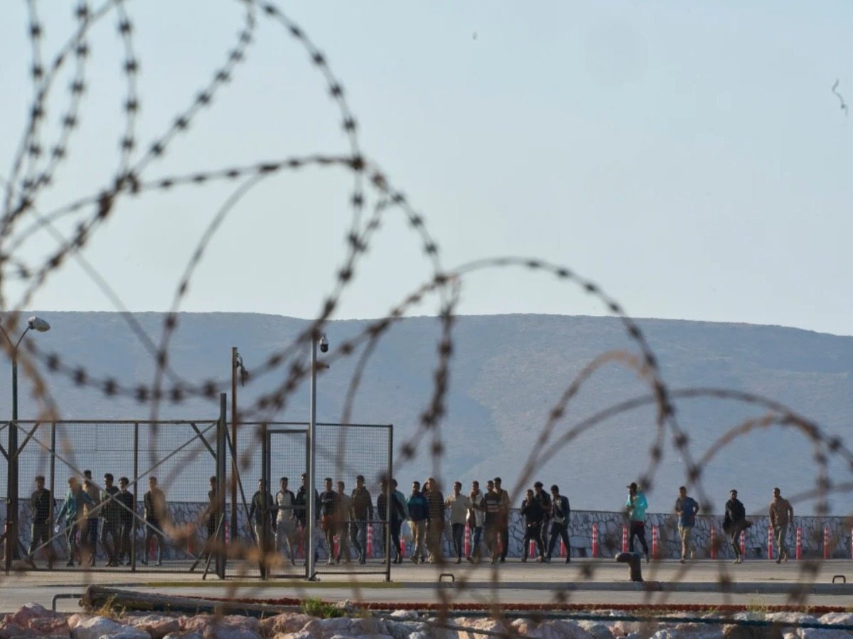 Rescued migrants walk through the port of Lavrio in Greece after arriving from south of Crete on Thursday, July 10, 2025.